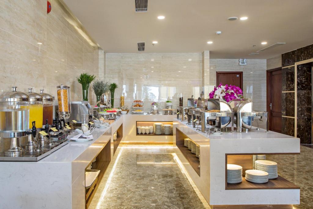 Restaurant dining room at Alisia Beach Hotel, with the sea beyond the windows