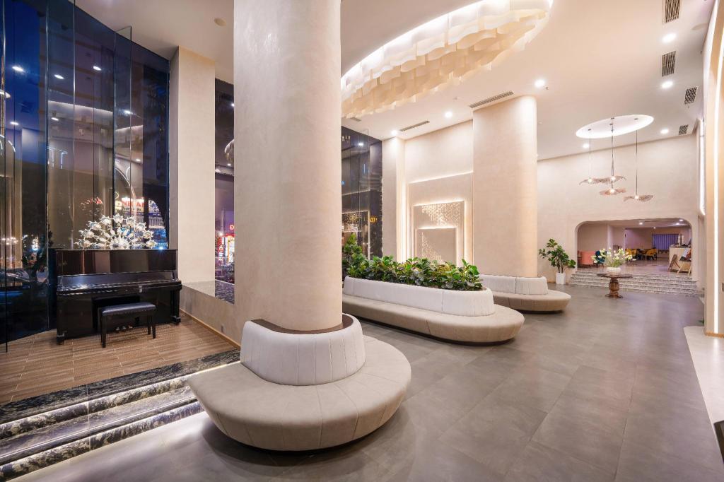 Lobby seating at Cicilia Danang Hotels & Spa, with chairs and the reception desk beyond