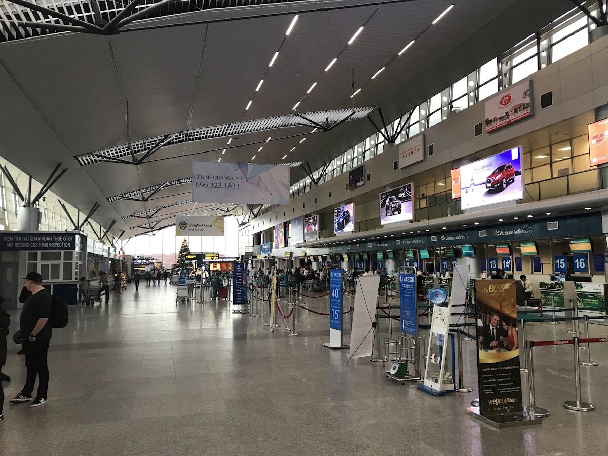 Da Nang International Airport terminal interior showing airline check-in counters and departure signage