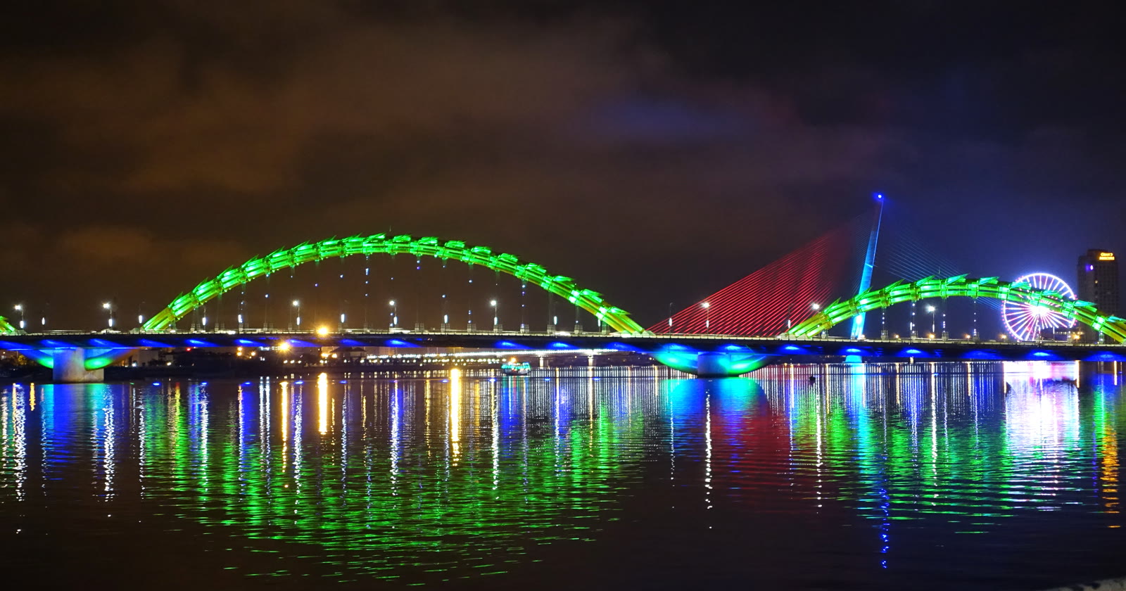 Dragon Bridge lit at night over the Han River in Da Nang